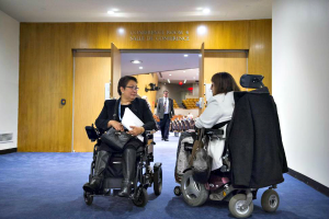 Image of two global leaders on disability issues in conversation outside a UN conference room