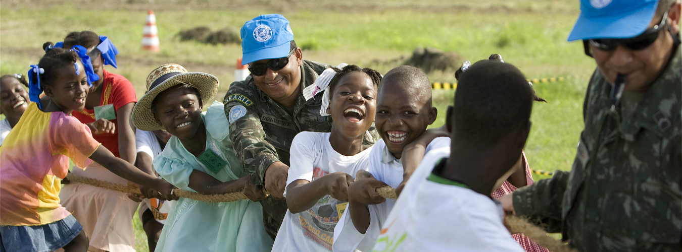 Members of the Brazilian battalion of the UN Stabilization Mission in Haiti (MINUSTAH) play tug of war with a group of local children during a civic day event in Cité Soleil, Haiti. UN Photo/Logan Abassi