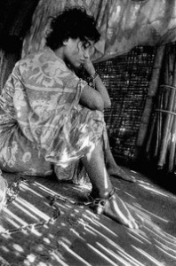 Image of woman in hut who is chained to the floor. WHO image by Muhammed entitled Unchained Soul