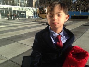 Image of child outside UN Headquarters building in New York to attend the World Down Syndrome Day 2016 Conference