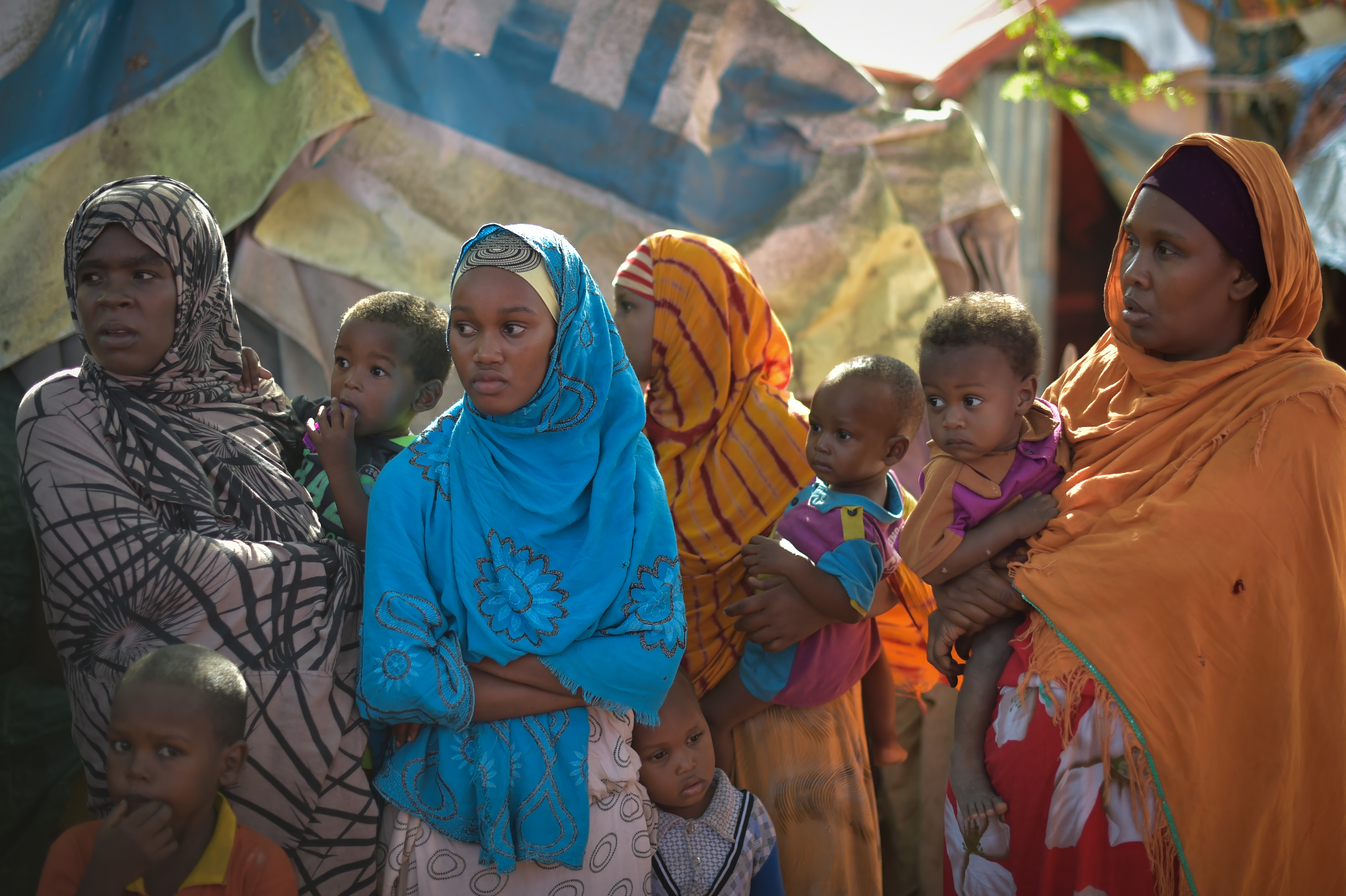 A group of Somali women stand near a water point at the Dayniile IDP camp on the outskirts of Mogadishu, Somalia, on March 6, 2017. UN Photo/Tobin Jones