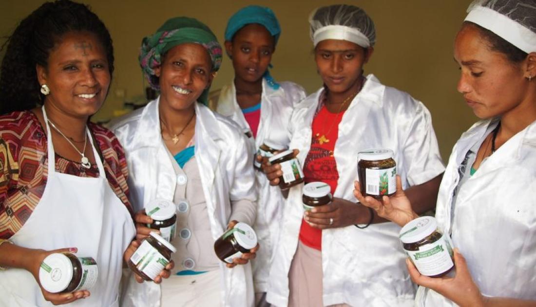 Women holding a product in jars