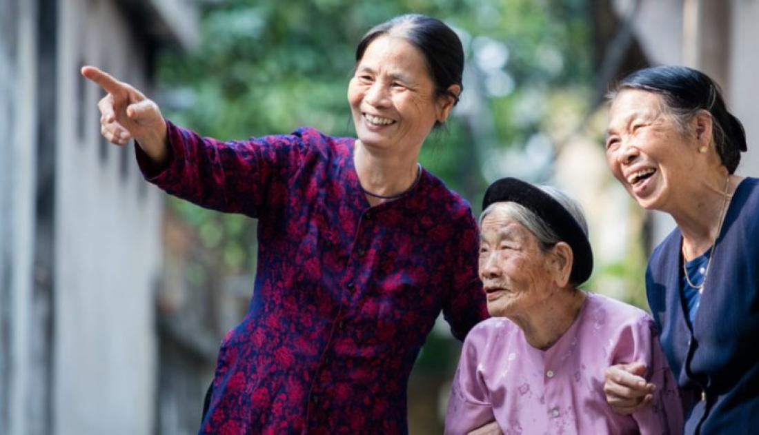Three older persons laughing