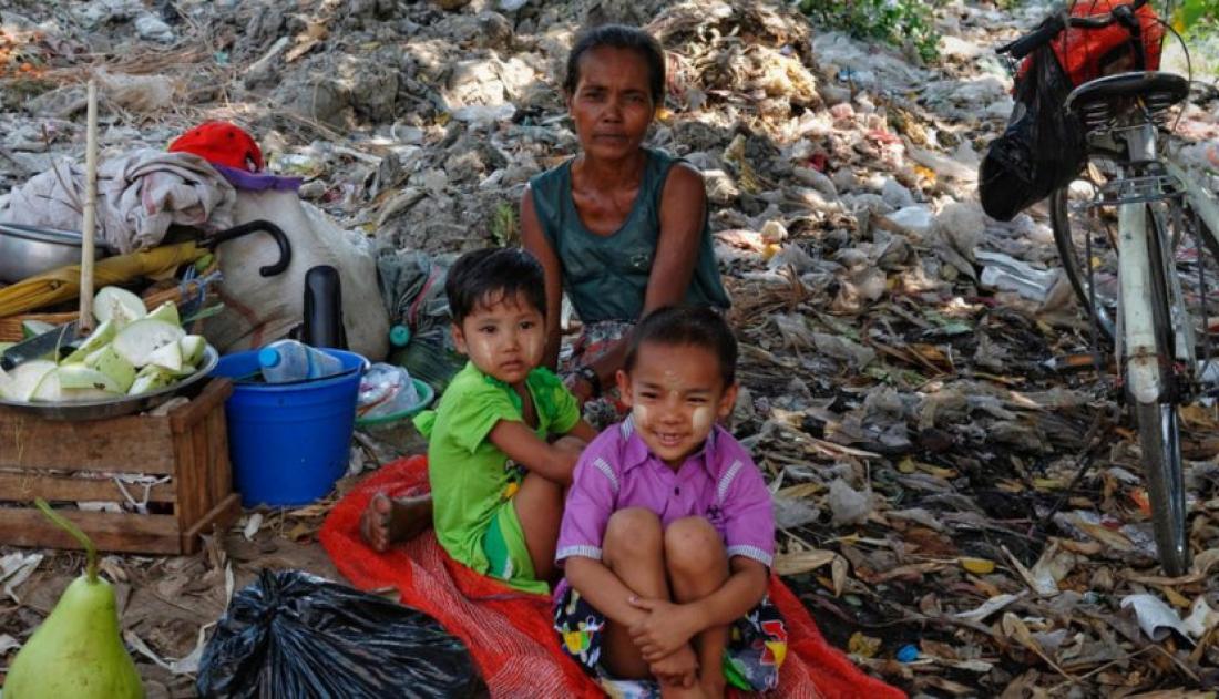 Young children sitting in a pile of trash