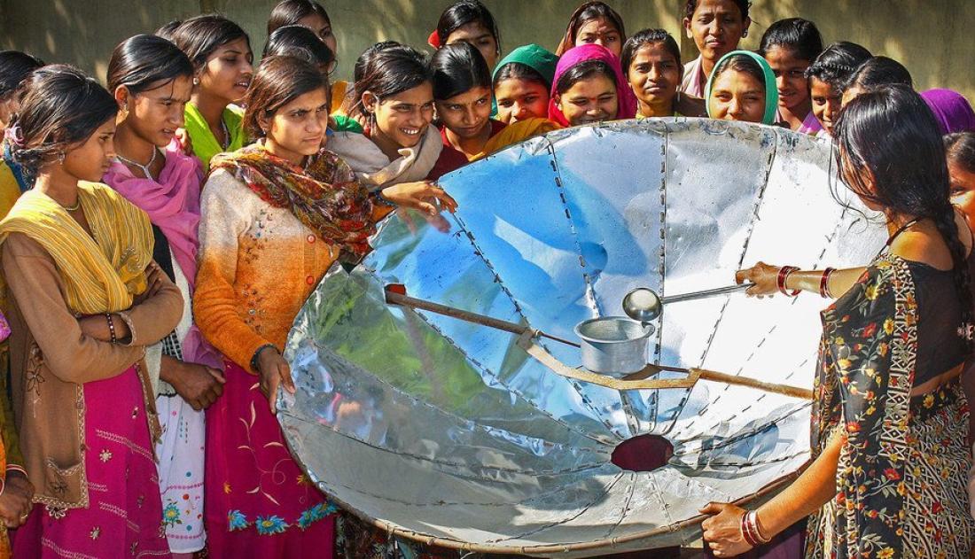 UNDP India In India, a woman demonstrates how to use a solar dish for cooking.