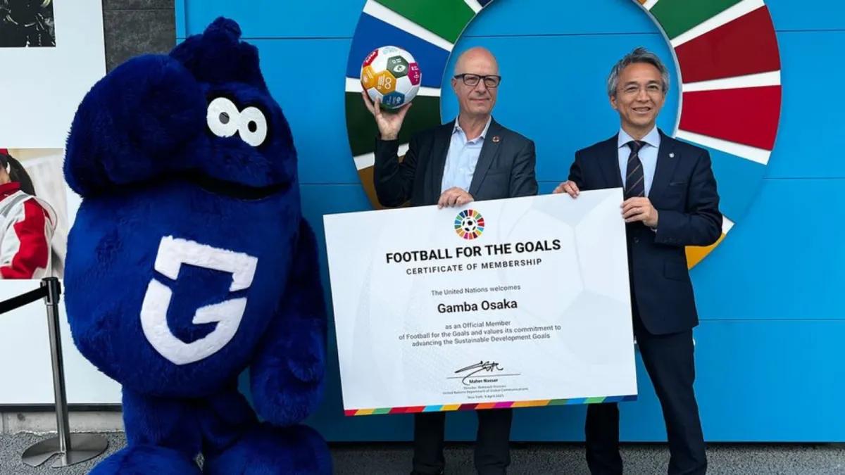 UN News/Daniel Dickinson The UN's Maher Nasser (left) and Shinji Ito of Gamba Osaka mark the Japanese club's membership of the Football for the goals initiative.