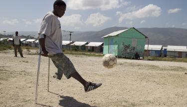 Players practice at a gravel filed in the middle of the camp. Many members of disabled soccer clubs in Port au Prince Haiti, live in a camp for displaced people specially for disabled people. 
Photo Logan Abassi UN/MINUSTAH