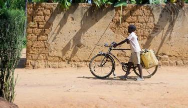 UN Photo/Manuel Elías: A child with a bicycle and water containers in the Mbyo Village in the Bugesera District of Rwanda.